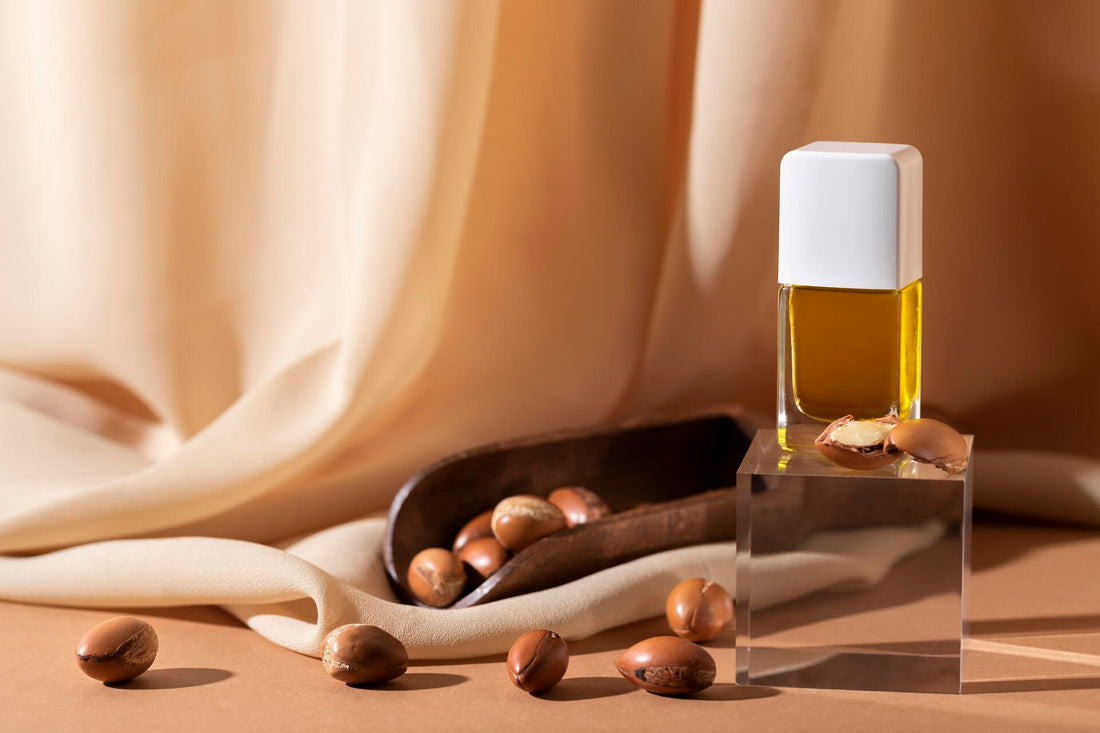 A glass bottle surrounded by Argan oil seeds